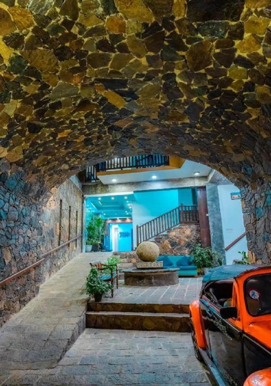 Historic stone fortress archway entrance and tropical grounds at Rock Fort Beach Resort